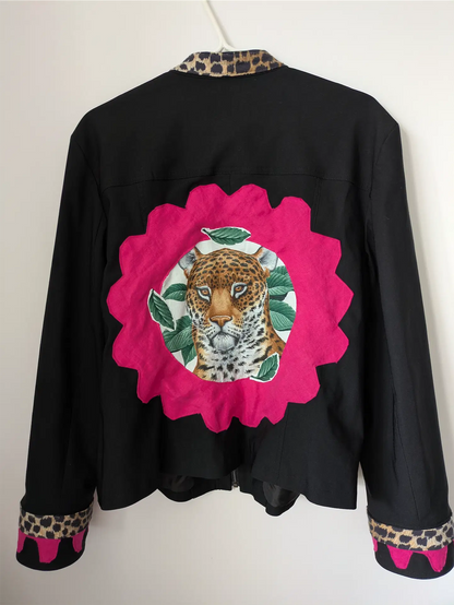 Black jacket with a pink floral patch featuring a leopard design on a white background