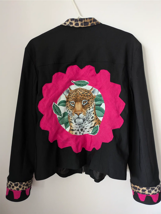 Black jacket with a pink floral patch featuring a leopard design on a white background