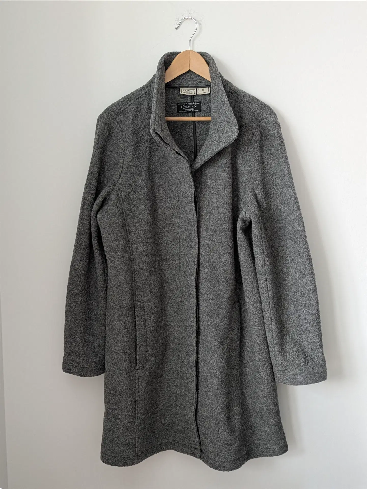 Gray coat on a hanger against a white background