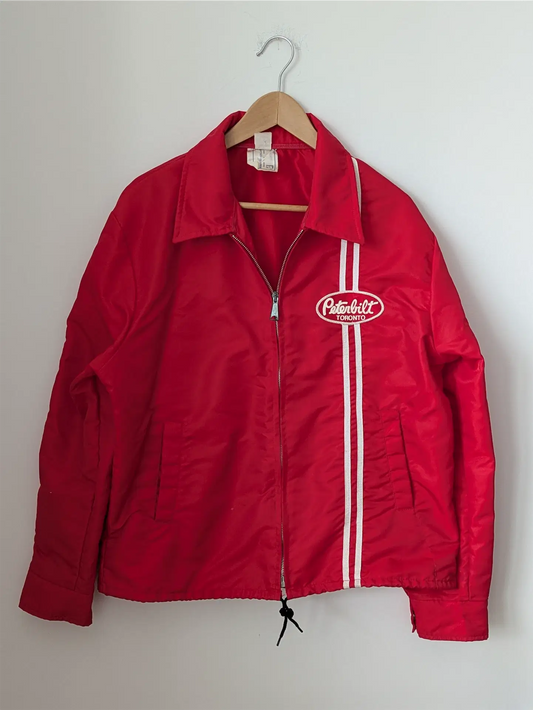 Red jacket with a logo on a hanger against a white background