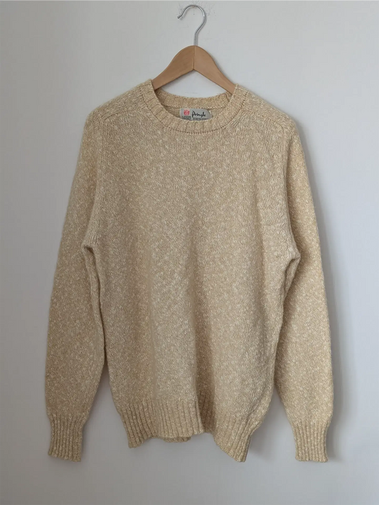 Beige sweater on a wooden hanger against a plain background